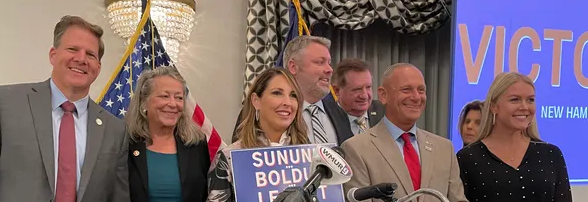 At unity breakfast, Gov. Chris Sununu (left) poses with Republican National Committee chair Ronna McDaniel (center) and Republican primary winners Bob Burns, Don Bolduc and Karoline Leavitt.